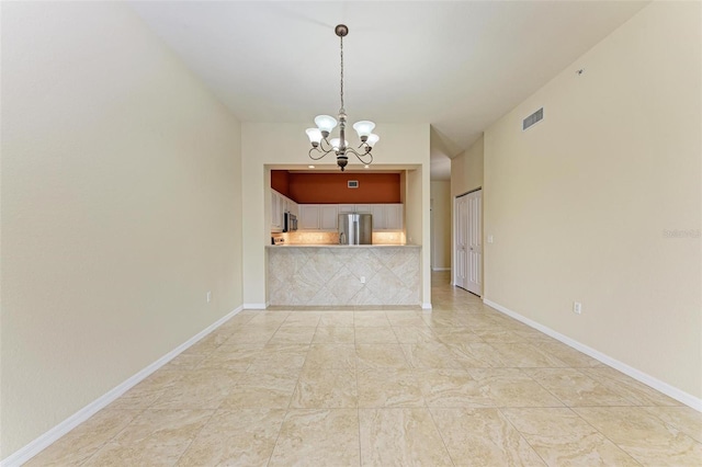 unfurnished living room with a chandelier