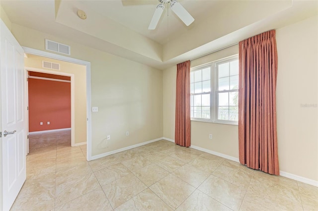 empty room featuring ceiling fan and light tile patterned floors