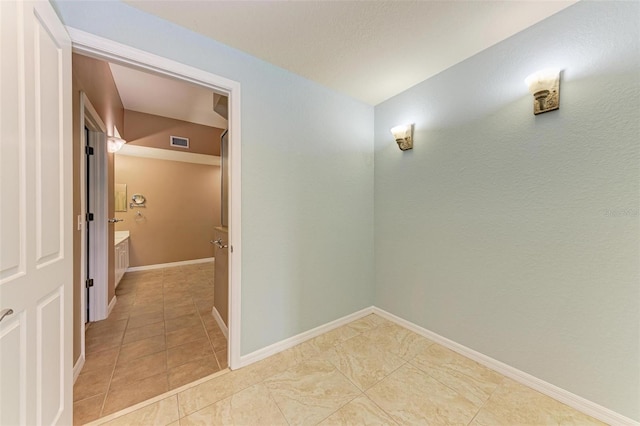 hall featuring light tile patterned floors