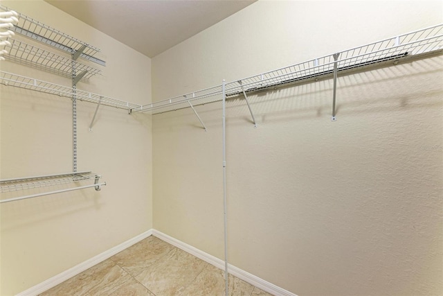 spacious closet with tile patterned floors