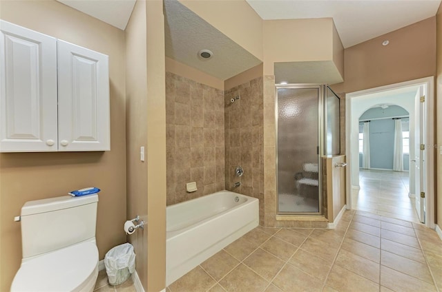 bathroom featuring tile patterned flooring, separate shower and tub, toilet, and a textured ceiling