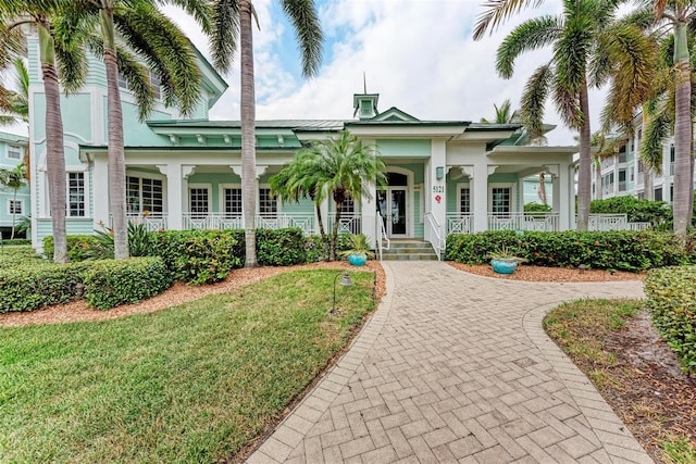 view of front of house with a porch and a front lawn