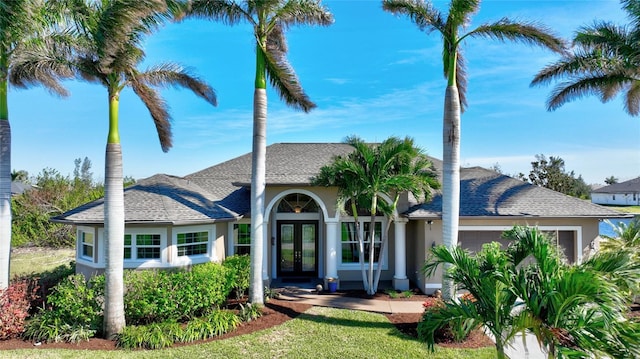 ranch-style house featuring french doors and a garage