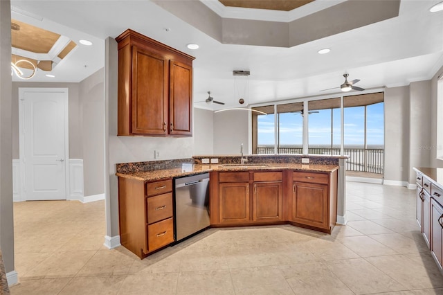 kitchen featuring ceiling fan, sink, stainless steel dishwasher, kitchen peninsula, and crown molding