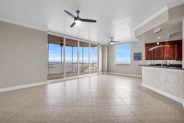 unfurnished living room featuring ceiling fan, ornamental molding, and light tile patterned floors