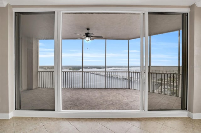 unfurnished sunroom featuring plenty of natural light and ceiling fan