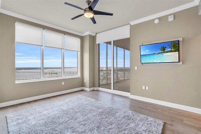 unfurnished room with hardwood / wood-style flooring, ceiling fan, and ornamental molding