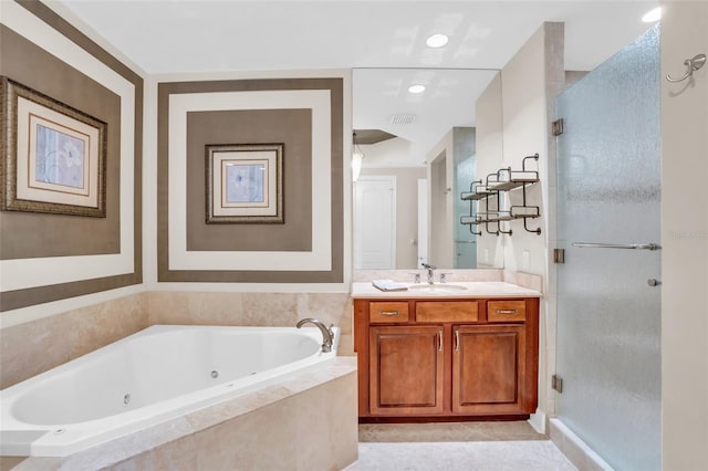 bathroom with tile patterned floors, vanity, and shower with separate bathtub