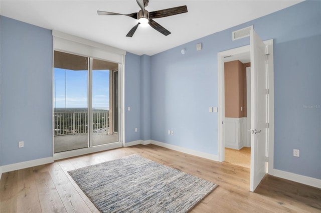 spare room with light hardwood / wood-style flooring and ceiling fan