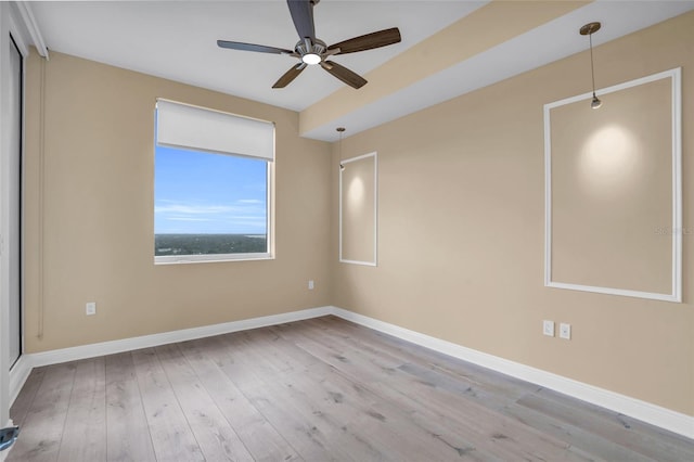 empty room with ceiling fan and light hardwood / wood-style floors