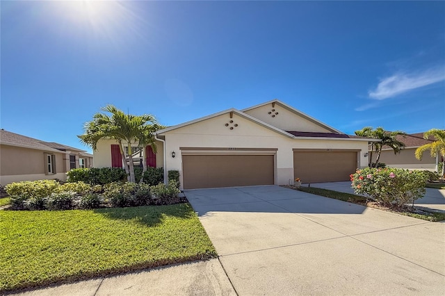 ranch-style house with a garage and a front lawn