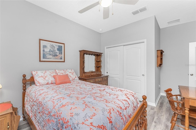 bedroom featuring light hardwood / wood-style flooring, ceiling fan, and a closet