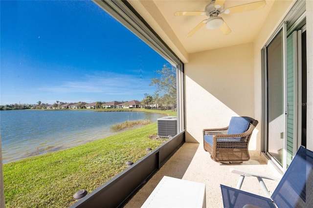 balcony with a water view, ceiling fan, and central AC unit