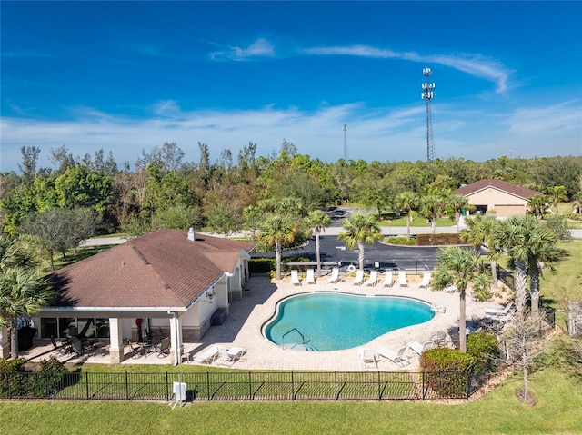 view of swimming pool with a patio and a yard