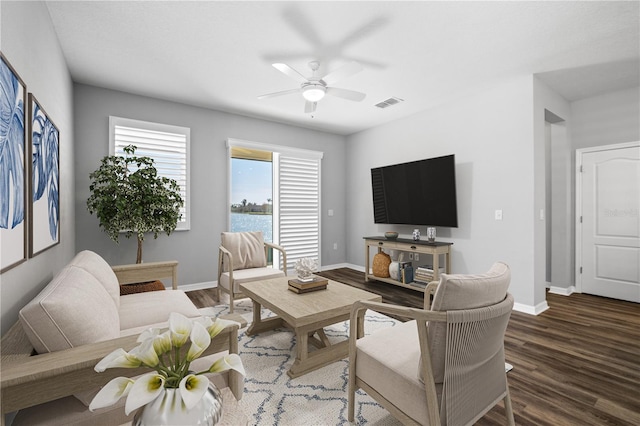 living room featuring dark hardwood / wood-style floors and ceiling fan