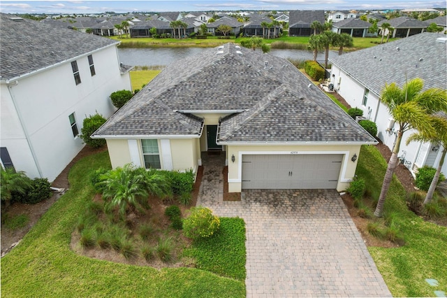 exterior space with a garage and a water view