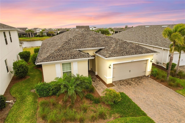 view of front of home featuring a water view and a garage