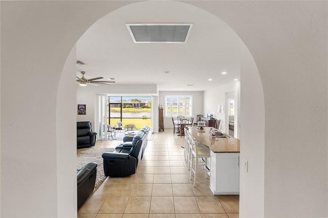 tiled living room featuring ceiling fan