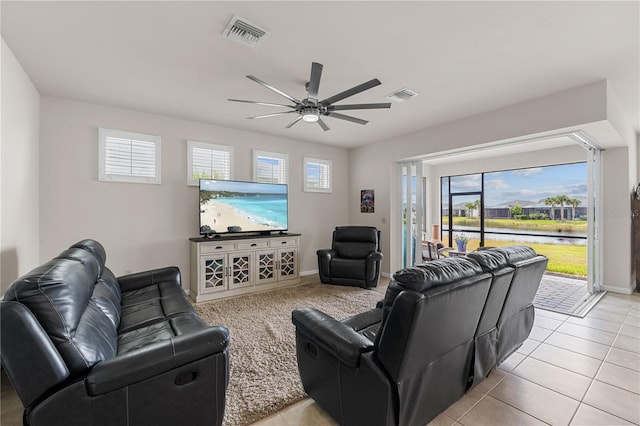 living room with ceiling fan and light tile patterned floors