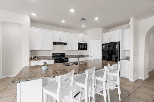 kitchen with white cabinets, sink, a kitchen island with sink, and black appliances