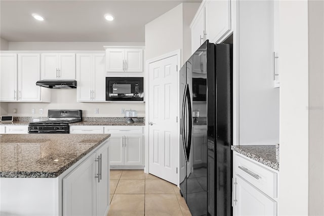 kitchen featuring black appliances, light tile patterned flooring, dark stone countertops, and white cabinetry