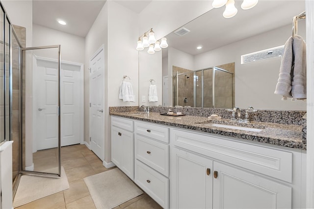 bathroom with tile patterned floors, vanity, and a shower with shower door