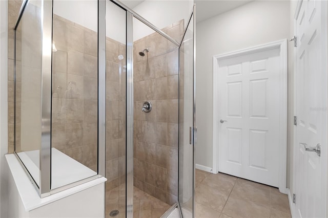 bathroom with tile patterned floors and an enclosed shower