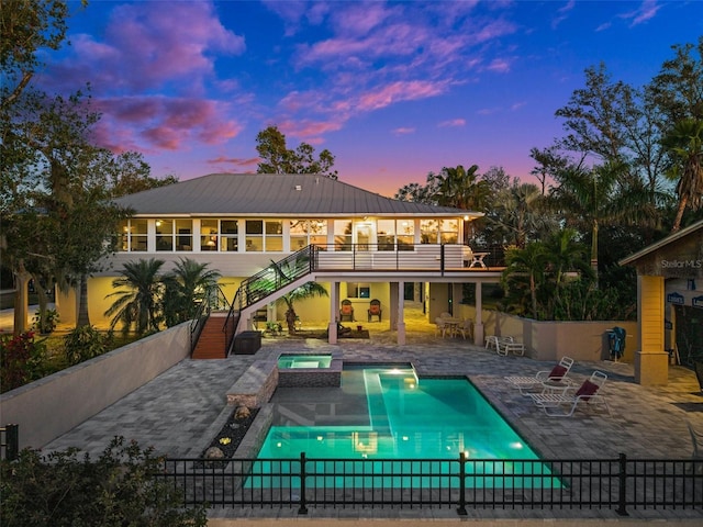 8625 SW County Road 769, Arcadia, FL 34269 - rear view of property featuring stairs, a patio area, a pool with connected hot tub, and metal roof
