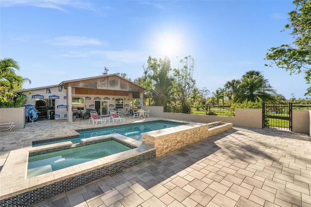 view of swimming pool with an in ground hot tub and a patio area