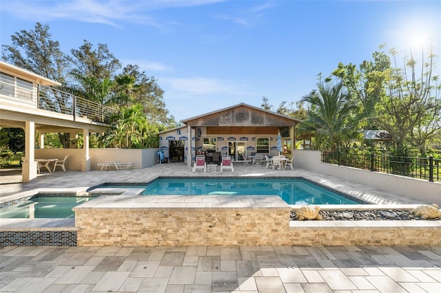 view of swimming pool with a gazebo, a patio, and an in ground hot tub