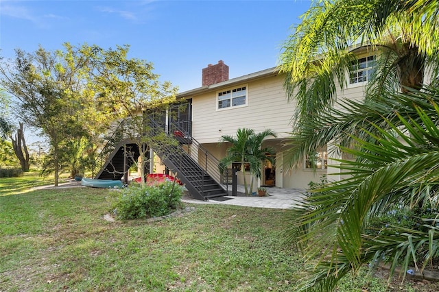 back of house featuring a yard and a patio area