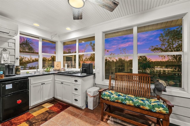 sunroom with a wall mounted AC and sink