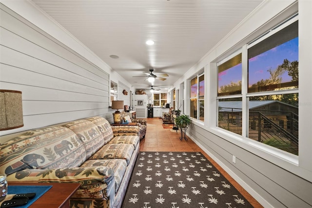 sunroom / solarium featuring ceiling fan