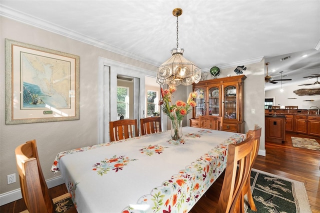 dining room featuring ornamental molding, sink, dark hardwood / wood-style floors, and ceiling fan with notable chandelier