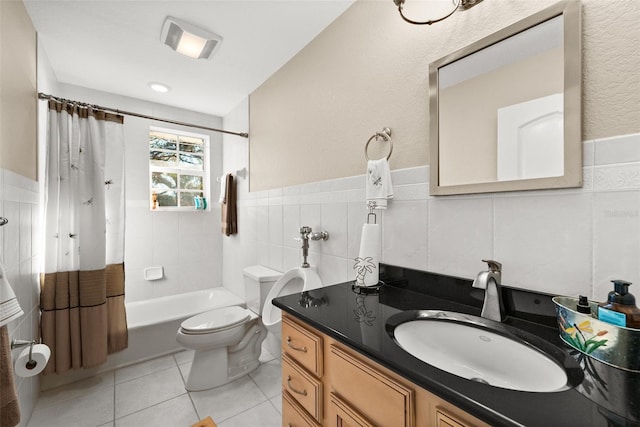 full bathroom featuring toilet, tile walls, vanity, shower / bath combo with shower curtain, and tile patterned flooring