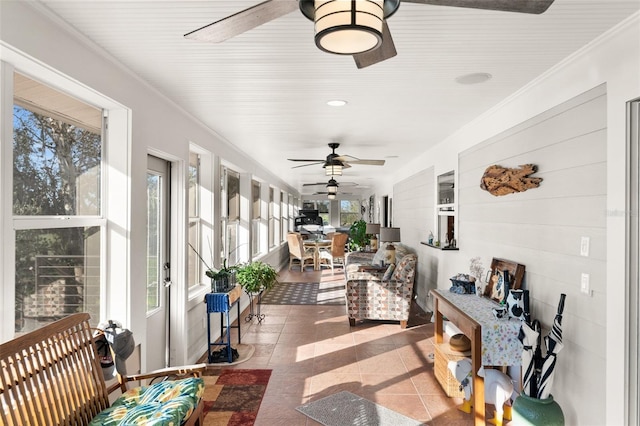 sunroom featuring ceiling fan