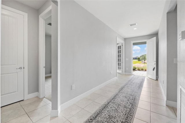 hall with light tile patterned floors