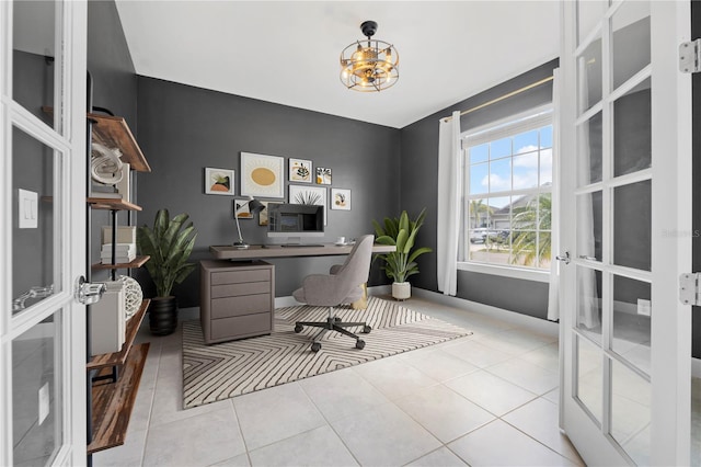 tiled office space featuring french doors and an inviting chandelier