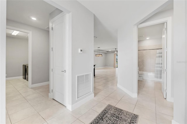 hall with light tile patterned floors