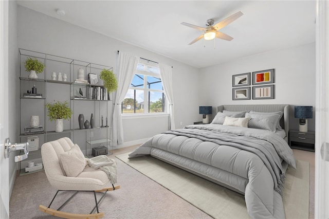 bedroom with ceiling fan and light colored carpet