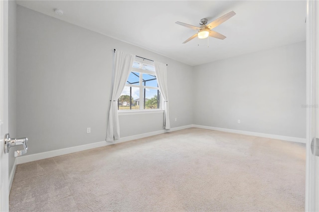 unfurnished room with ceiling fan and light colored carpet