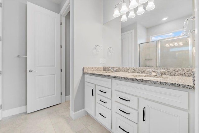 bathroom featuring tile patterned flooring, vanity, and an enclosed shower