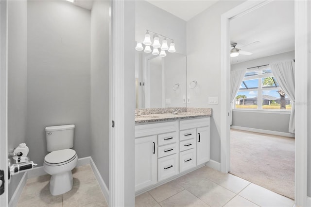 bathroom featuring tile patterned flooring, vanity, toilet, and ceiling fan