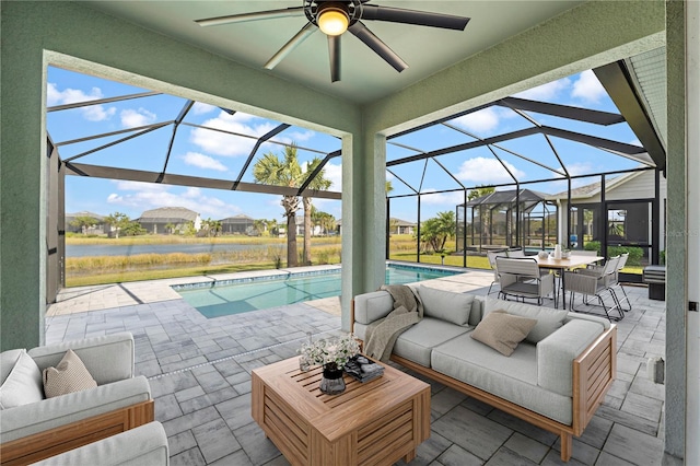 view of patio / terrace with an outdoor hangout area, glass enclosure, and ceiling fan