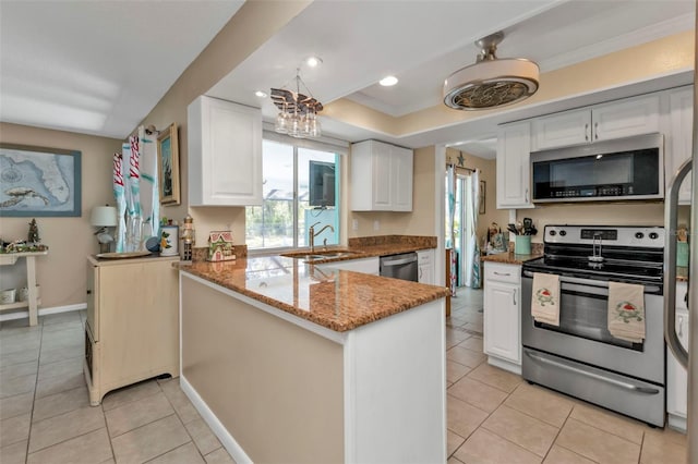 kitchen with white cabinets, kitchen peninsula, and appliances with stainless steel finishes