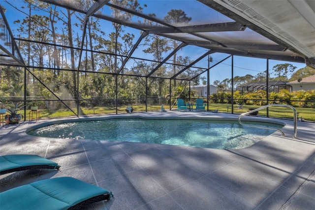 view of pool featuring glass enclosure and a patio area