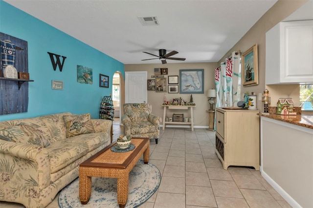 tiled living room with ceiling fan