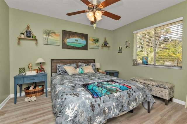 bedroom with ceiling fan and light wood-type flooring