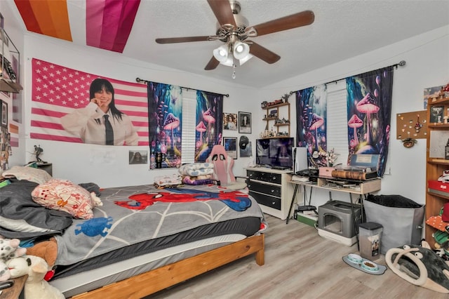 bedroom with hardwood / wood-style floors and ceiling fan