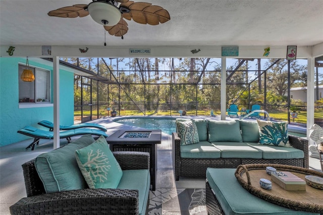 view of patio with a lanai, outdoor lounge area, and ceiling fan